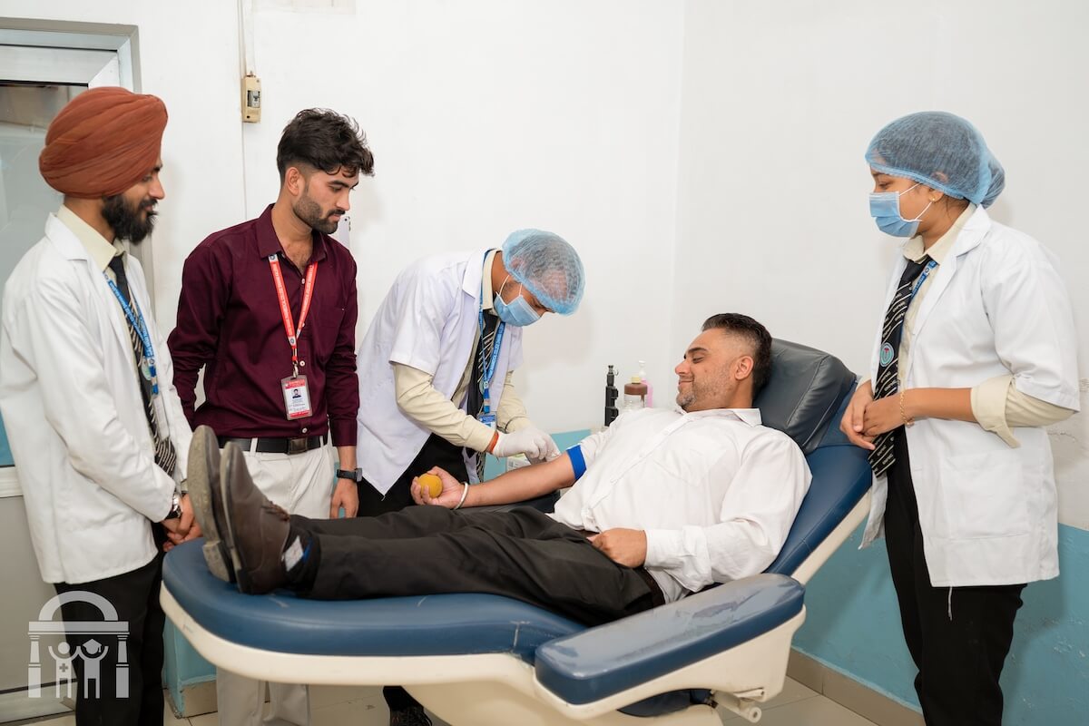 Medical lab science students learning to draw blood at Guru Nanak Paramedical College in Nawanshahr District, Punjab