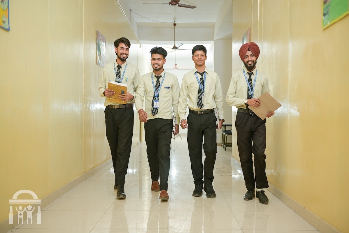 male students walking down hallway at paramedical college in Punjab