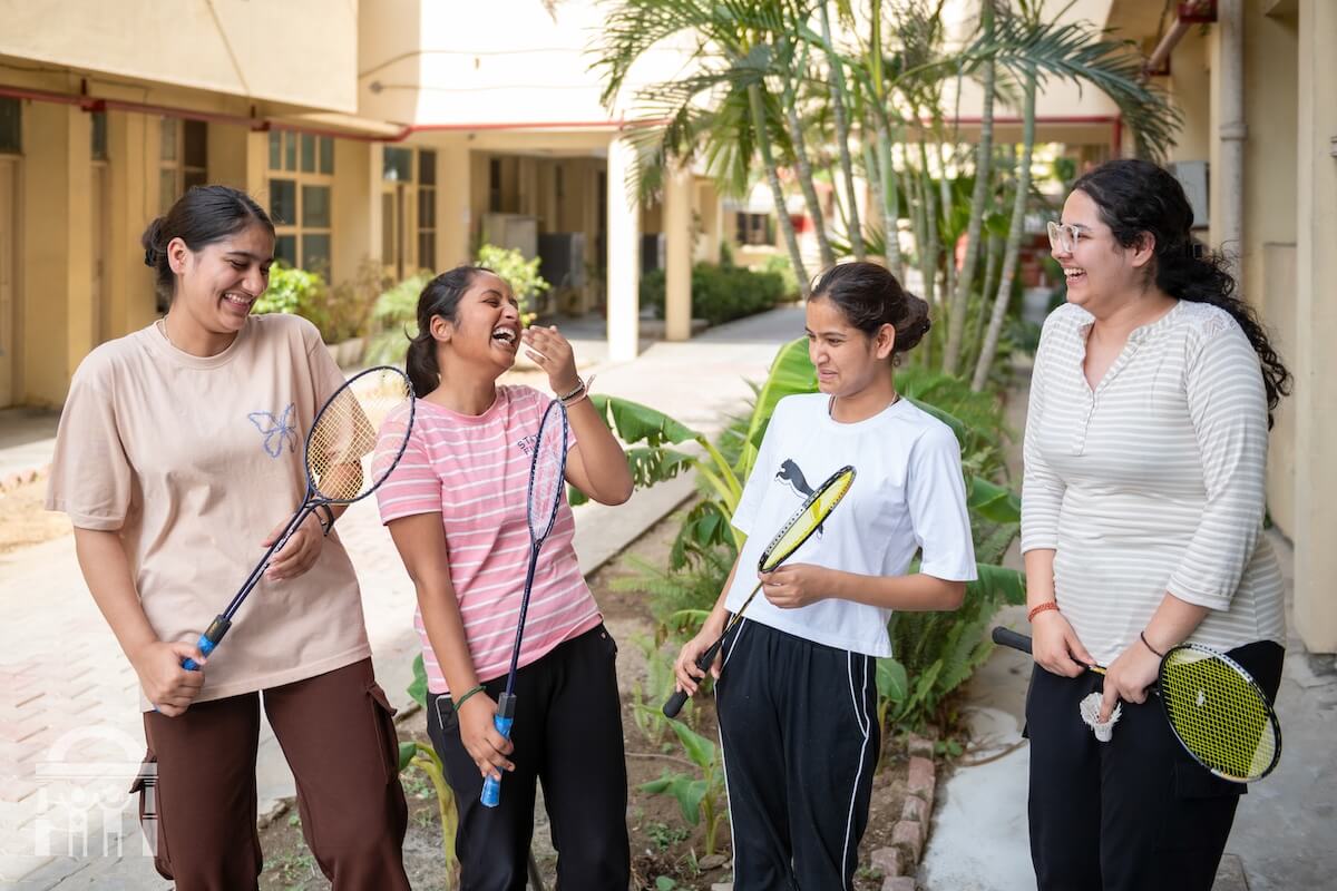 Allied health students with badminton rackets on campus - Guru Nanak Paramedical College