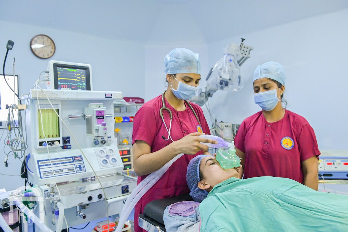 Surgical team placing ventilator on patient in operating theatre at Guru Nanak Mission Hospital Dhahan Kaleran near Banga in Punjab