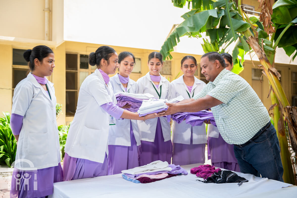 Students picking up laundry from washerman service at Guru Nanak Paramedical College